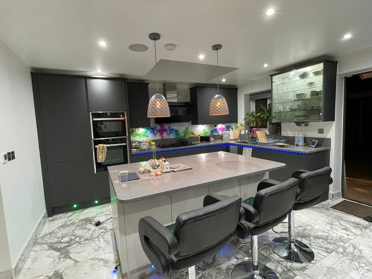 Dark contemporary fitted kitchen with feature lighting