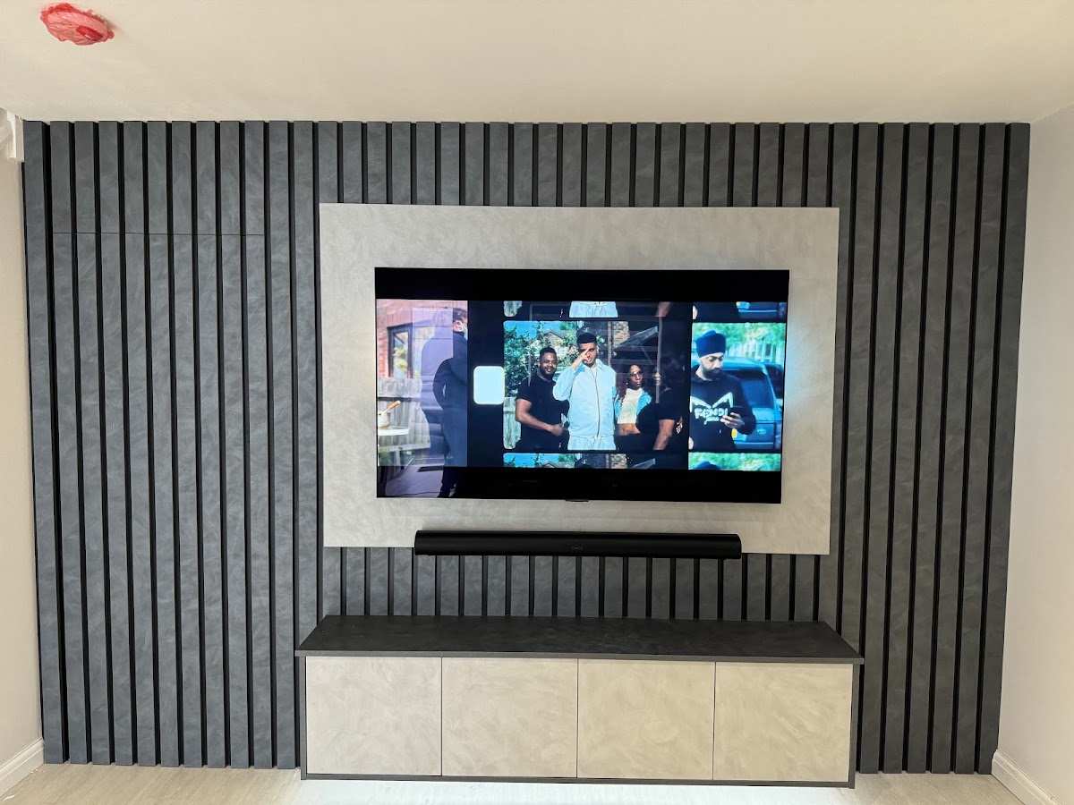 Charcoal slatted media wall with integrated television and storage