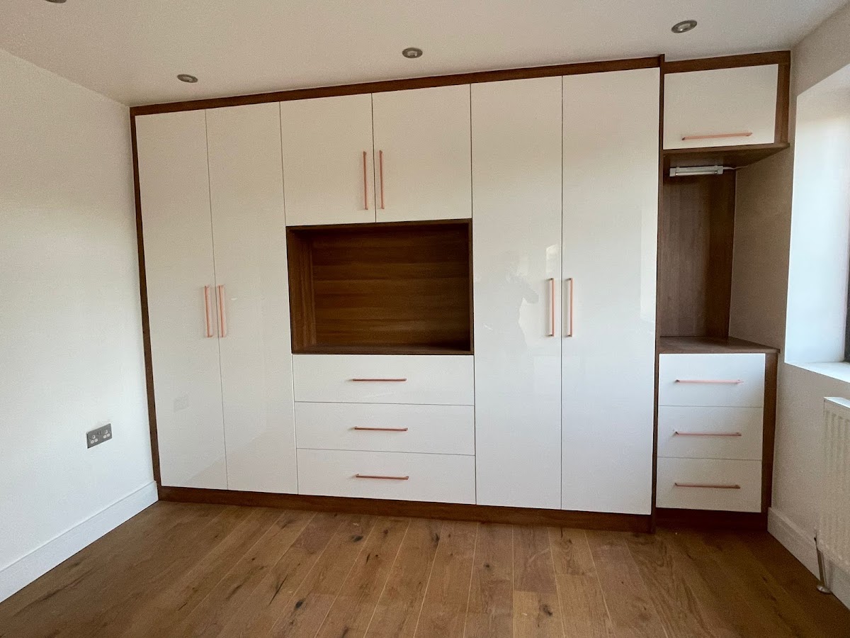 White fitted bedroom wardrobe with timber detail